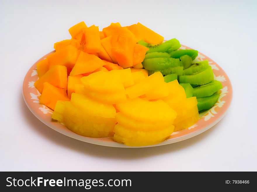 Isolated tray of Kiwi, Pineapple and cantaloupe. Isolated tray of Kiwi, Pineapple and cantaloupe