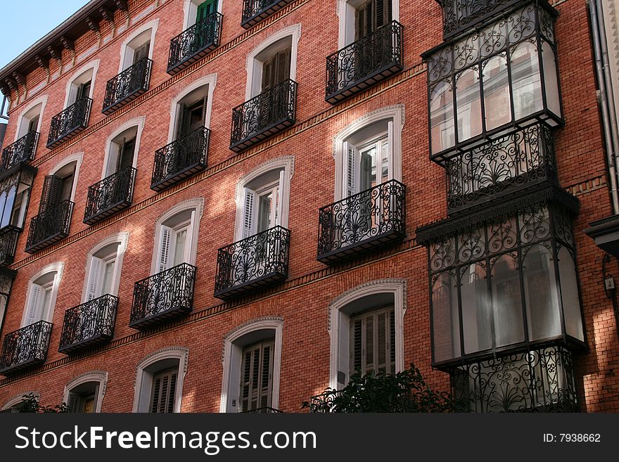 THe front of a living house with balconies. Madrid, Spain. THe front of a living house with balconies. Madrid, Spain.