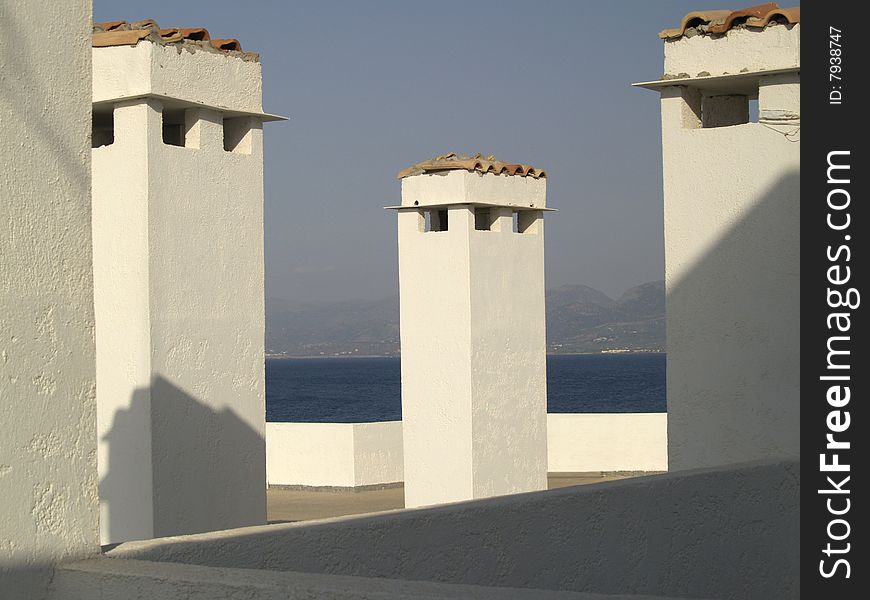 Ð¡himneys on the roof in Crete, Greece