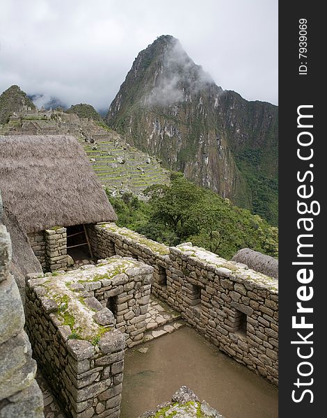 Machu Picchu is a pre-Columbian Inca site located 2,430 metres (8,000 ft) above sea level. It is situated on a mountain ridge above the Urubamba Valley in Peru, which is 80 kilometres (50 mi) northwest of Cusco and through which the Urubamba River flows. The river is a partially navigable headwater of the Amazon River.