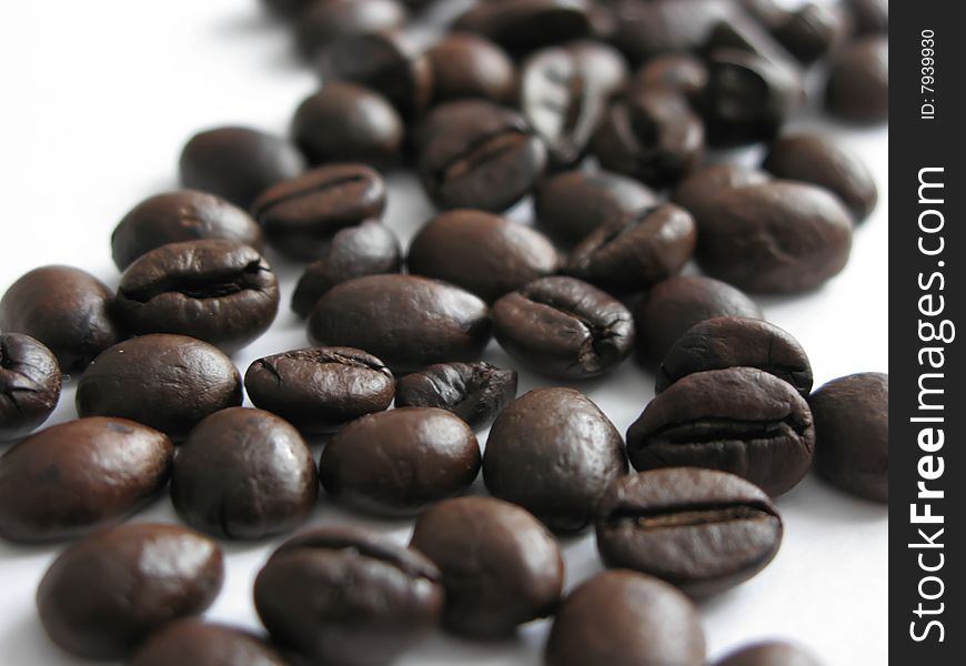 Close-up view of the roasted coffee beans raise thoughts about a cup of coffee