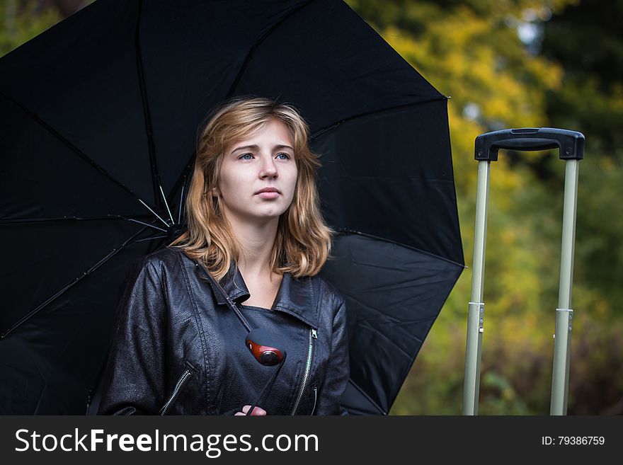 Girl, umbrella and rails in autumn day