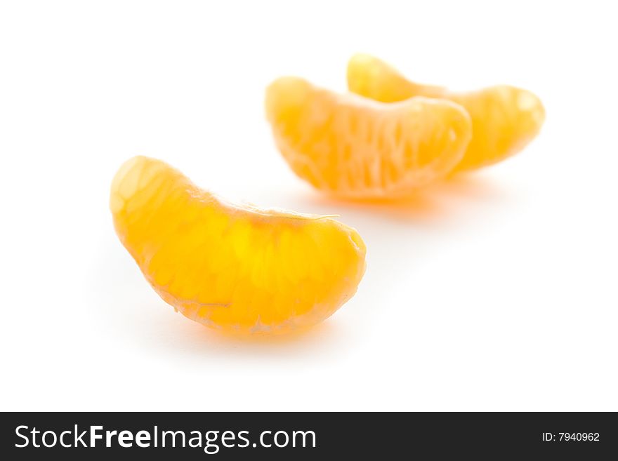 Several tangerine segments  on a  white background