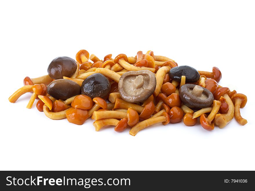 Some marinated honey agarics and black milk mushrooms isolated on the white background. Some marinated honey agarics and black milk mushrooms isolated on the white background