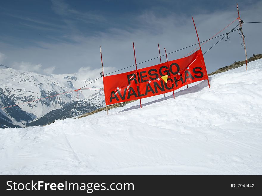 Snow landscape with a blue sky and a warning for avalanches, Spain