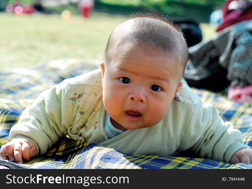 Bright picture of adorable chinese baby boy put Down the body
