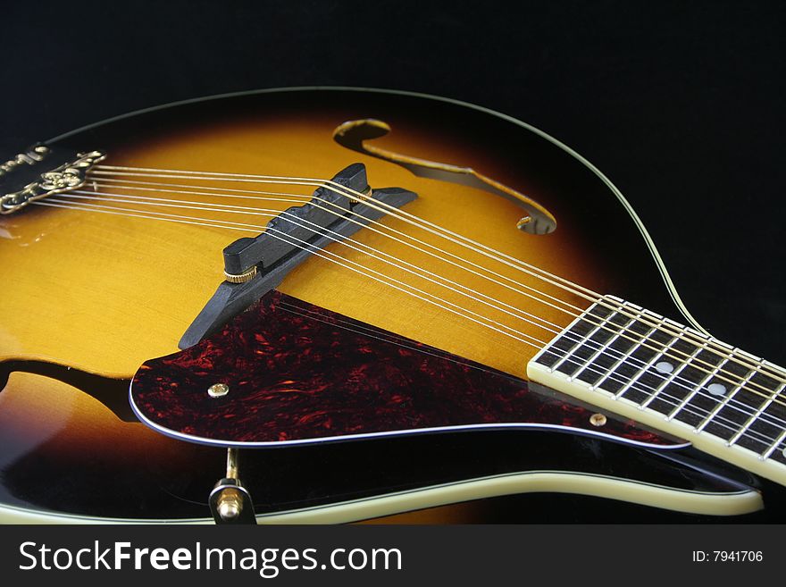 Mandolin, a musical instrument isolated on black background. Mandolin, a musical instrument isolated on black background