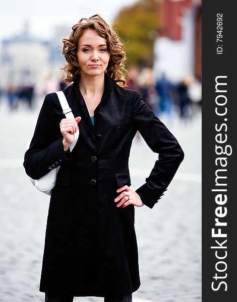 Attractive smiling woman standing by Kremlin in Moscow