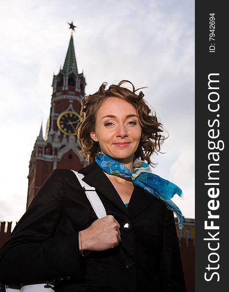 Smiling woman standing by Kremlin in Moscow