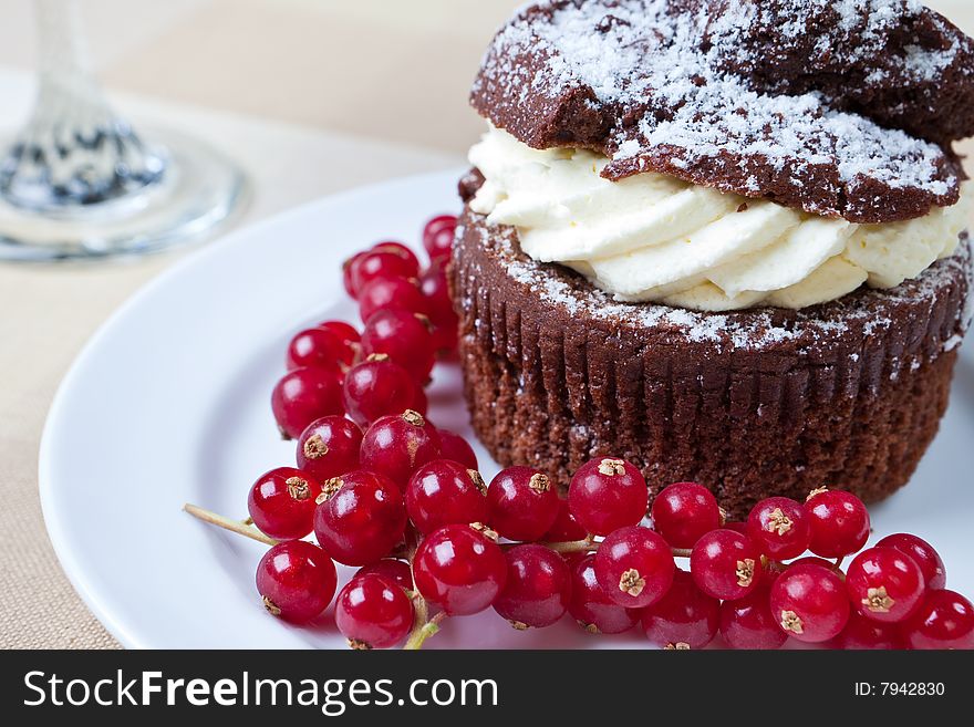 Delicious chocolate and cream muffin on a plate