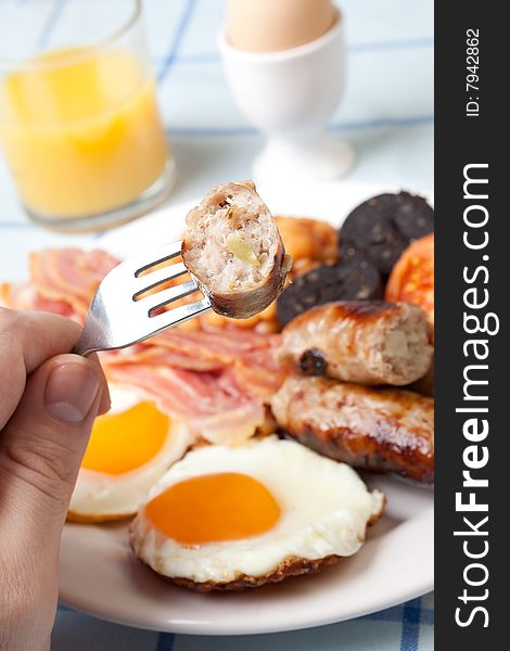 Traditional english breakfast - egg, sausages, beans, bacon and black pudding with toast. Traditional english breakfast - egg, sausages, beans, bacon and black pudding with toast