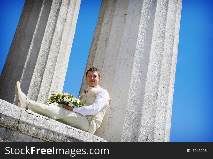 Groom with flowers waiting for a bride