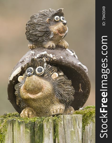 Mother and baby hedgehog puppet over a trunk