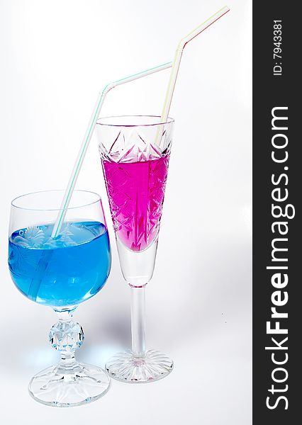 Two wineglass with drink blue and magenta colors