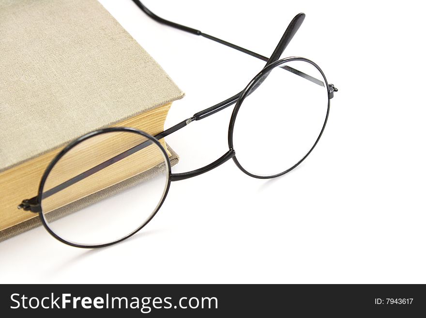 Book and glasses on a white background