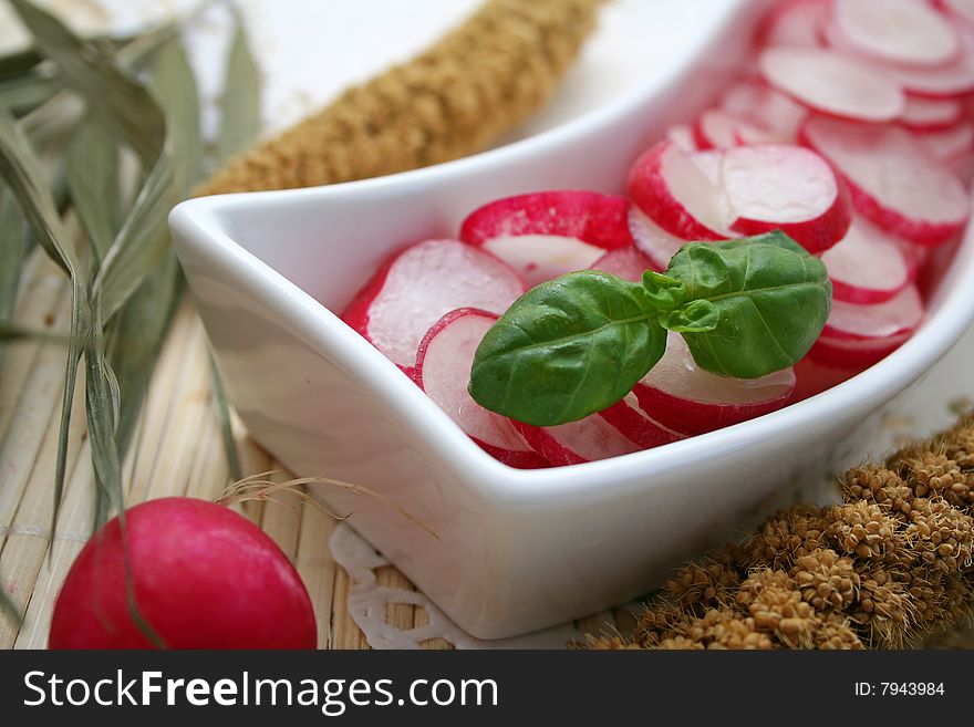 A fresh salad of red radish with basil