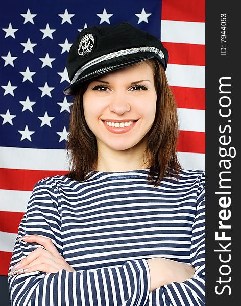 Beautiful sailor standing near the American flag