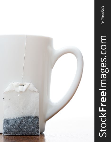 Teabag and teacup isolated on white background