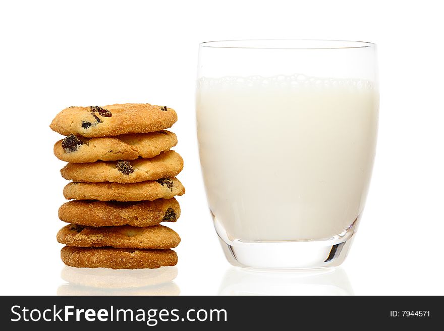 A stack of cookies and glass of milk with shadow isolated on a white background. A stack of cookies and glass of milk with shadow isolated on a white background.