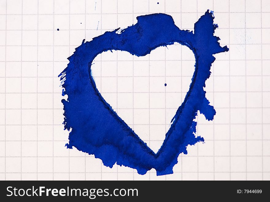 Heart shaped blue ink blot on paper