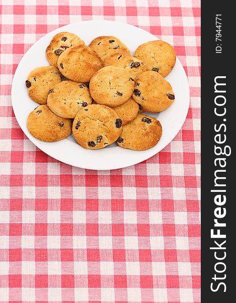Plate of cookies on checked tablecloth. Composition allows you to add text or something else.