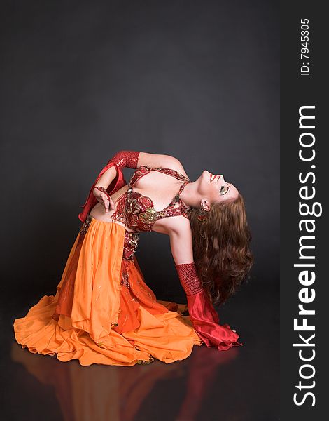 Belly Dancer wearing a red costume with jewelery. Belly Dancer wearing a red costume with jewelery