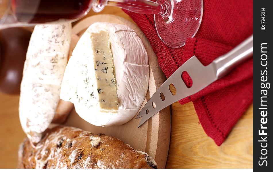 French cheese,salami,loaf of bread and red wine. French cheese,salami,loaf of bread and red wine