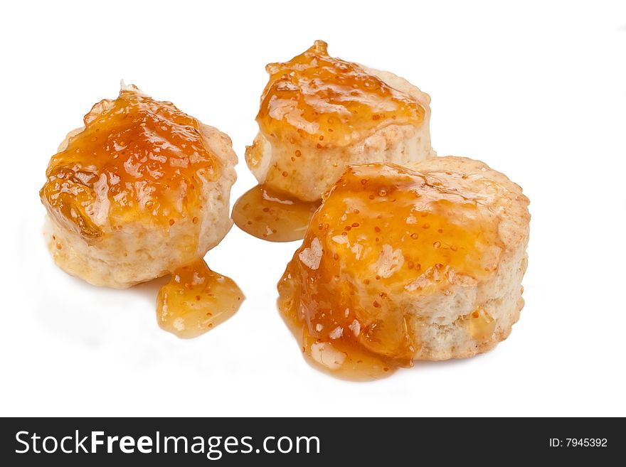 Three small baking powder biscuits covered with fig preserves. Three small baking powder biscuits covered with fig preserves