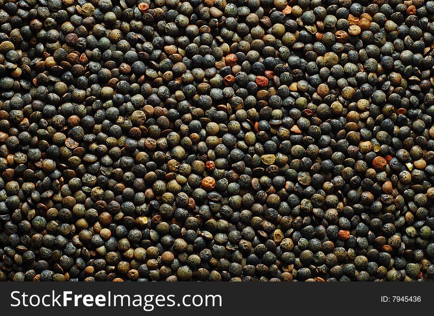 Black lentil background. food background