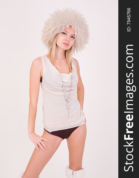 Beautiful girl in furry hat, studio shot