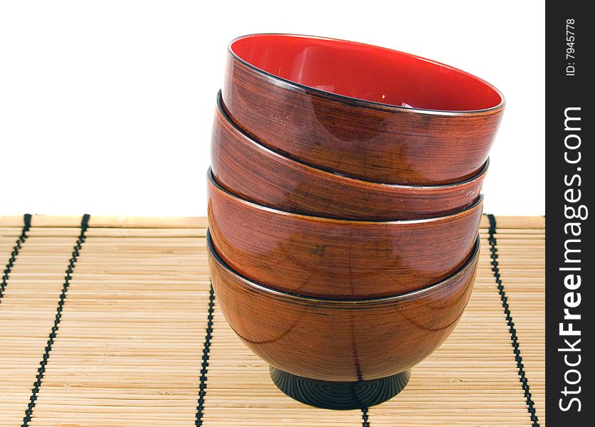 A pile of four Japanese rice bowls on bamboo placemat. A pile of four Japanese rice bowls on bamboo placemat