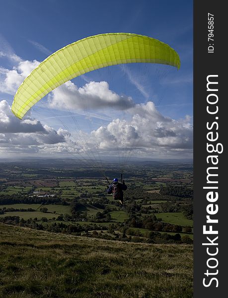 A paraglider with a lofty view of English countryside