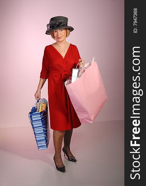 Attractive Older Lady Holding Shopping Bags