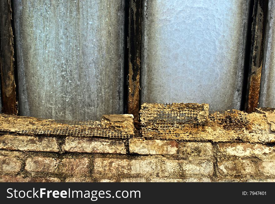 Dirty frosted glass of old skylight with rusted beams brick and mesh