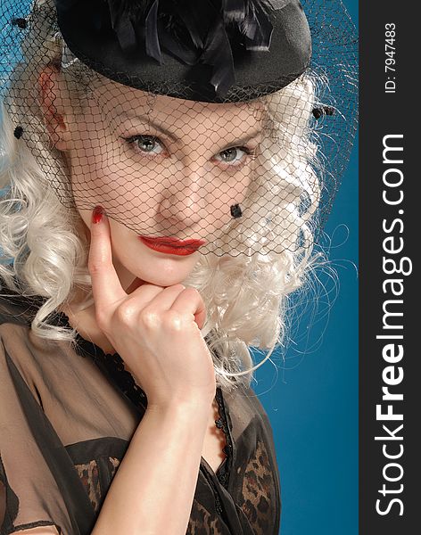 Gorgeous retro girl in forties hat with feathers