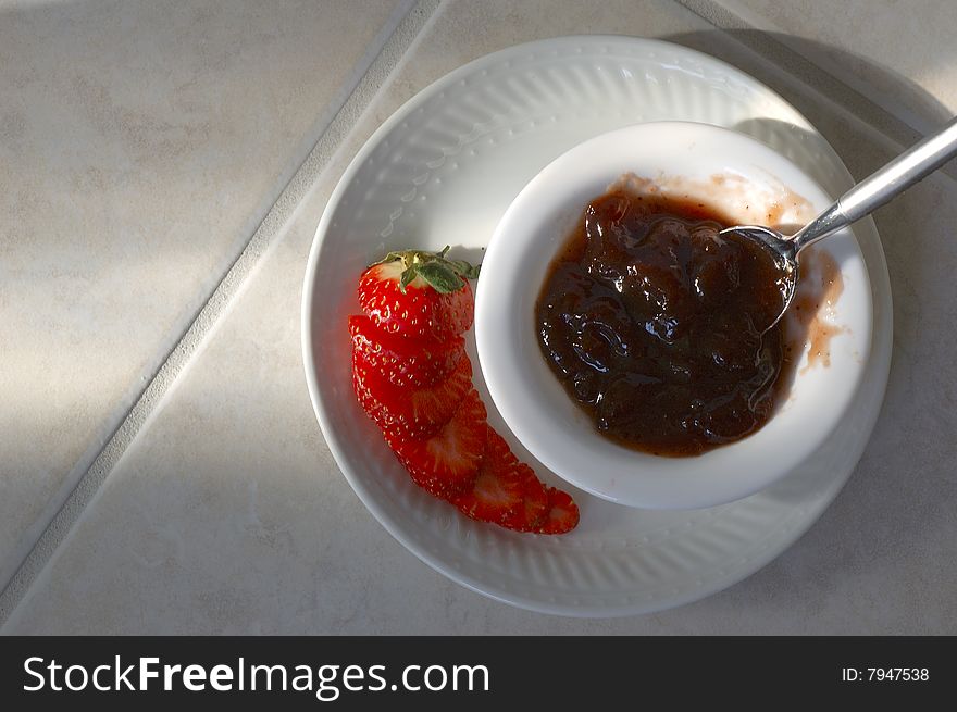 Closeup of strawberry jam and sliced strawberry. Closeup of strawberry jam and sliced strawberry