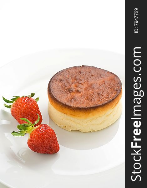 Cheesecake with fresh strawberries and blackberry jam isolated over white