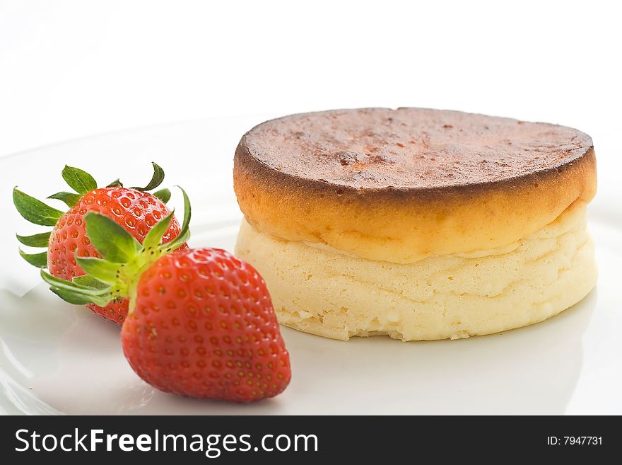 Cheesecake with fresh strawberries and blackberry jam isolated over white