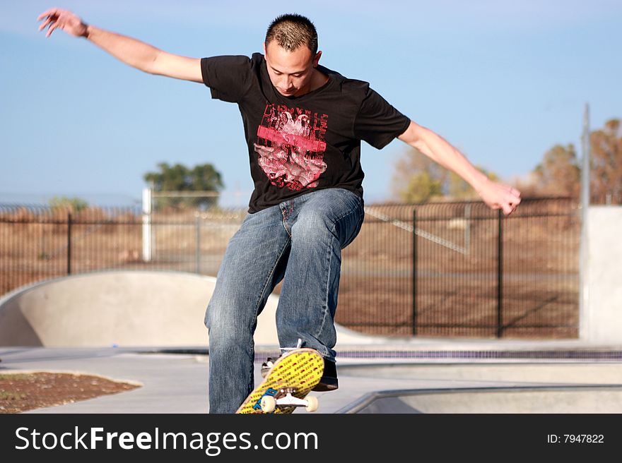 Skateboarder balancing on his skateboard.