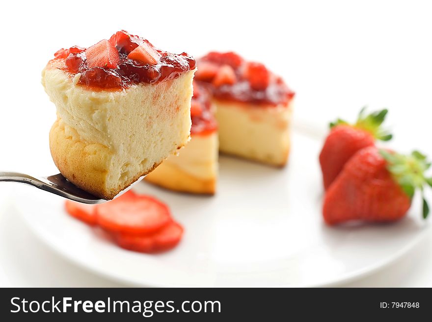 Cheesecake with fresh strawberries and blackberry jam isolated over white