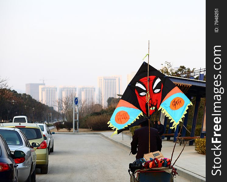 A kite pedlar on the road in a city. raw available