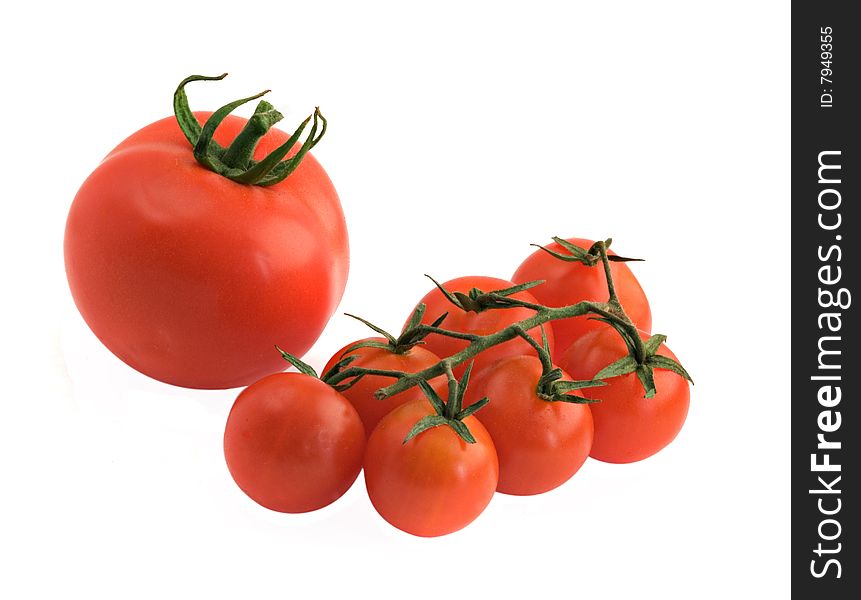 Large tomato and branch of cherry tomatoes