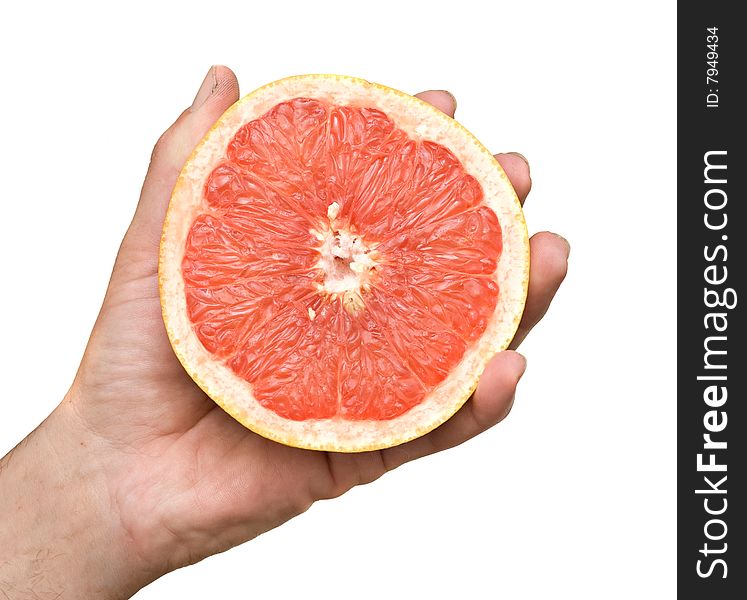 Hand holding section of red grapefruit