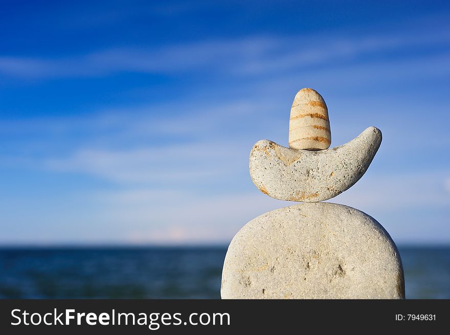 Sea pebble against the dark blue sky in the summer on a beach. Sea pebble against the dark blue sky in the summer on a beach