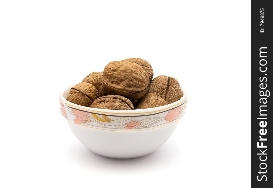 Walnuts in saucer isolated on white background with  path