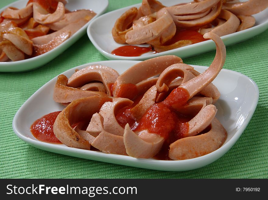 Fresh sausages poured with ketchup