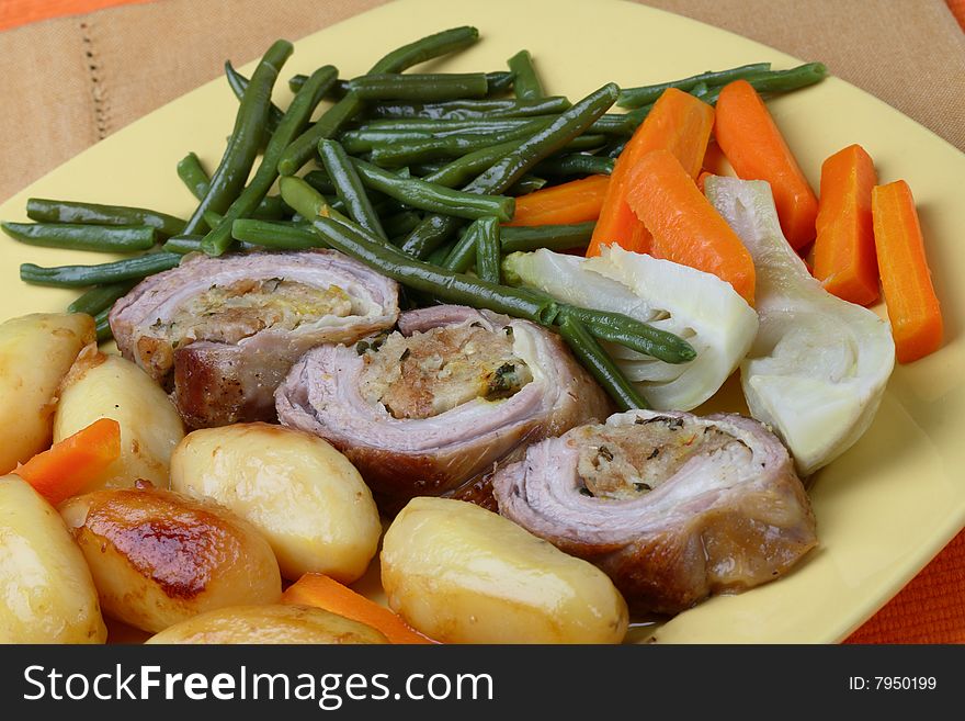 Filled rolled lamb with roast potatoes and vegetable