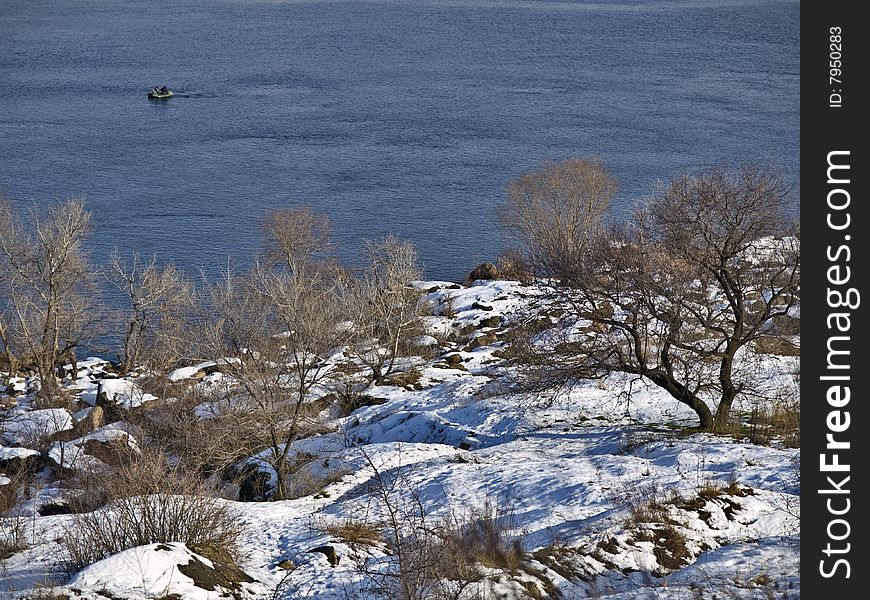 Winter landscape with fishermen and rocky bank. Winter landscape with fishermen and rocky bank