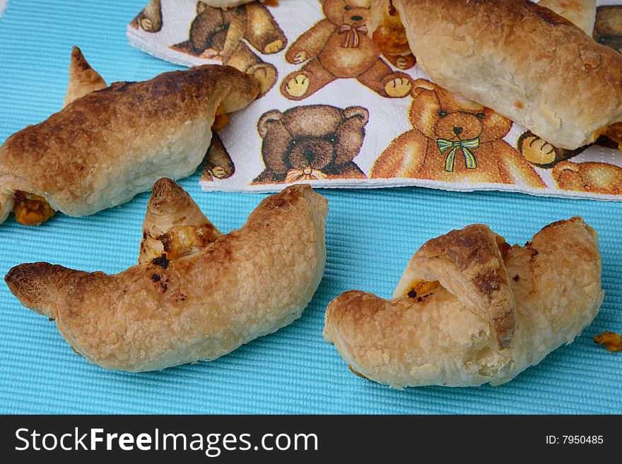 Baked puff pastry rolls filled with carrots on table