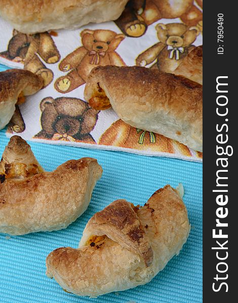 Baked puff pastry rolls filled with carrots on table